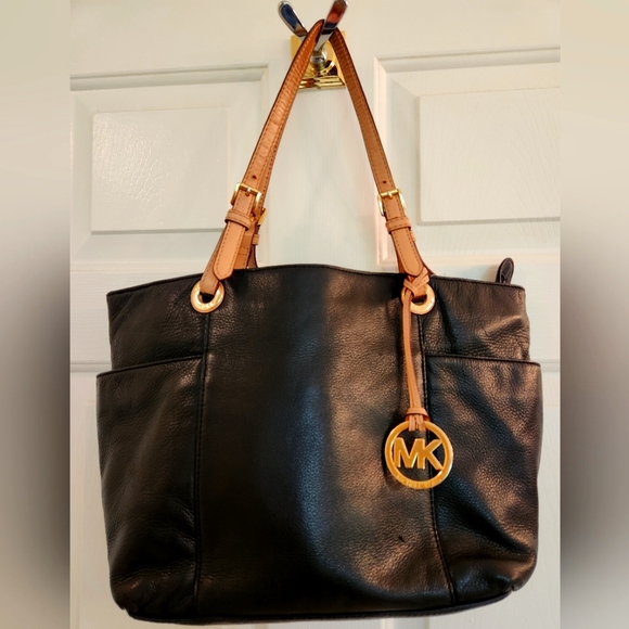 Michael Kors black leather handbag with tan trim. Size 11.5" l x 4.5w x 10" h. - Picture 1 of 3